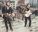Paul McCartney & John Lennon tijdens het 'Apple Rooftop Concert'