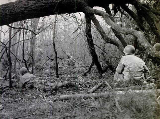 SOLDIERS CROUCHING IN THE HUERTGEN FOREST